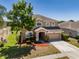 Charming two-story home with lush landscaping and a well-maintained lawn at 7852 Stoney Hill Dr, Wesley Chapel, FL 33545