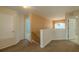 Upstairs hallway with carpet flooring offers access to bedrooms and bathrooms, with neutral walls and plenty of light at 7852 Stoney Hill Dr, Wesley Chapel, FL 33545