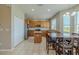 Bright kitchen featuring an island, stainless steel appliances, and a dining area with views of the backyard at 7852 Stoney Hill Dr, Wesley Chapel, FL 33545