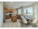 Well-equipped kitchen with stainless steel appliances, an island, and a cozy dining area bathed in natural light at 7852 Stoney Hill Dr, Wesley Chapel, FL 33545