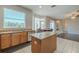 Bright kitchen features an island, granite countertops, stainless steel appliances, and a large window overlooking the backyard at 7852 Stoney Hill Dr, Wesley Chapel, FL 33545