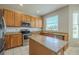 Spacious kitchen boasting stainless steel appliances, ample counter space, and a convenient center island at 7852 Stoney Hill Dr, Wesley Chapel, FL 33545