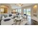 Bright living room with stylish furniture, hardwood floors, and sliding glass doors leading to the outdoors at 7852 Stoney Hill Dr, Wesley Chapel, FL 33545