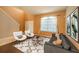 Inviting living room boasts neutral walls, plush seating, a stylish rug, and bright, natural light at 7852 Stoney Hill Dr, Wesley Chapel, FL 33545
