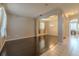 Open living room with hardwood floors, neutral walls, and a seamless transition to the adjacent dining area at 7852 Stoney Hill Dr, Wesley Chapel, FL 33545