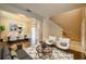 Spacious living room with hardwood floors, comfortable seating, and seamless transitions to the dining area and entryway at 7852 Stoney Hill Dr, Wesley Chapel, FL 33545
