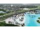 Aerial image of the house with community lagoon featuring sandy beaches and a waterpark for endless fun at 7912 Yale Harbor Dr, Wesley Chapel, FL 33545