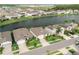 Aerial view featuring a home near the lake and surrounding neighborhood at 7912 Yale Harbor Dr, Wesley Chapel, FL 33545