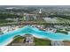 Aerial image featuring home near community lagoon, with sandy beaches and a waterpark, plus nearby houses at 7912 Yale Harbor Dr, Wesley Chapel, FL 33545