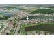 An aerial view of a home in a lakeside community with well-maintained landscaping and access to a waterfront view at 7912 Yale Harbor Dr, Wesley Chapel, FL 33545