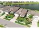 Aerial view showcasing the home's manicured lawn and prime location near the serene lake at 7912 Yale Harbor Dr, Wesley Chapel, FL 33545