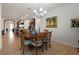 Dining area with modern light fixture, table, and chairs; view of kitchen and brick archway beyond at 7912 Yale Harbor Dr, Wesley Chapel, FL 33545