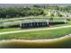 Aerial shot of Epperson Lagoon's entrance featuring lush greenery, a decorative fountain, and well-kept walking paths at 7912 Yale Harbor Dr, Wesley Chapel, FL 33545