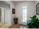 Bright foyer featuring tile flooring, a glass door, and stylish decor at 7912 Yale Harbor Dr, Wesley Chapel, FL 33545