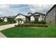 Inviting single-story home featuring a lush green lawn and a two-car garage at 7912 Yale Harbor Dr, Wesley Chapel, FL 33545