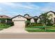 Charming single-story home featuring a well-manicured lawn and a two-car garage at 7912 Yale Harbor Dr, Wesley Chapel, FL 33545