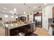 Kitchen with granite island, stainless steel appliances and dark wood cabinets, seamlessly connecting to the living area at 7912 Yale Harbor Dr, Wesley Chapel, FL 33545