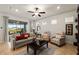 Comfortable living room with neutral decor, plush seating, and a view of the screened patio and backyard at 7912 Yale Harbor Dr, Wesley Chapel, FL 33545