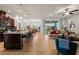 Open-concept living area with kitchen island, dining space, and living room with sliding glass doors to patio at 7912 Yale Harbor Dr, Wesley Chapel, FL 33545