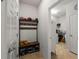 Functional mud room featuring shoe storage, hooks, and entry to laundry room with washer and dryer at 7912 Yale Harbor Dr, Wesley Chapel, FL 33545