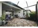 Enclosed patio featuring outdoor seating and cooking area at 7912 Yale Harbor Dr, Wesley Chapel, FL 33545