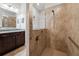 Bathroom showcasing tiled walk-in shower with glass door, grab bars, and dual shower heads at 7912 Yale Harbor Dr, Wesley Chapel, FL 33545