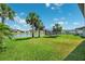 Lush backyard featuring a trampoline and serene water views at 8496 Starlight Loop, Parrish, FL 34219