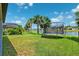 Lush backyard featuring a trampoline and serene water views at 8496 Starlight Loop, Parrish, FL 34219