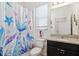 Bathroom featuring colorful mermaid themed shower curtain, single sink, and standard toilet at 8496 Starlight Loop, Parrish, FL 34219