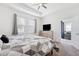 Carpeted bedroom with ceiling fan, natural light, and neutral paint at 8496 Starlight Loop, Parrish, FL 34219