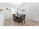 Dining area with a six-person table under a chandelier, and neutral décor at 8496 Starlight Loop, Parrish, FL 34219