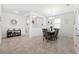 Open concept dining room with tile floors, and a six person dining table under a chandelier at 8496 Starlight Loop, Parrish, FL 34219