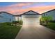 Charming single-story home featuring a two-car garage and landscaped front yard at 8496 Starlight Loop, Parrish, FL 34219