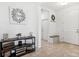 Inviting foyer featuring neutral tile flooring, decorative accents, and a convenient storage bench and access to other rooms at 8496 Starlight Loop, Parrish, FL 34219