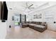 Bright living room with tile flooring, large sectional sofa and access to the outdoor living area at 8496 Starlight Loop, Parrish, FL 34219