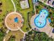 Overhead view of community playground and splash pad with blue water features at 8496 Starlight Loop, Parrish, FL 34219