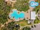 Aerial view of community pool and splashpad area surrounded by lush greenery at 8496 Starlight Loop, Parrish, FL 34219