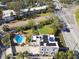 Aerial view of white block home with inground pool, fenced yard and mature trees at 1020 38Th N Ave, St Petersburg, FL 33704