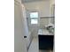 Charming renovated bathroom features a tiled floor and a navy blue vanity at 1020 38Th N Ave, St Petersburg, FL 33704
