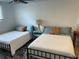 This bedroom features two twin beds, bedside tables and lamps, and carpet at 1020 38Th N Ave, St Petersburg, FL 33704