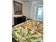 Stylish bedroom with hardwood floors, colorful art, and a view to the bathroom at 1020 38Th N Ave, St Petersburg, FL 33704