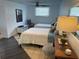 Bright bedroom featuring two beds, tiled floor, a ceiling fan, and a view of the outdoors at 1020 38Th N Ave, St Petersburg, FL 33704