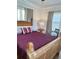 A cozy bedroom with a wooden bed frame, bedside table, and neutral decor at 1020 38Th N Ave, St Petersburg, FL 33704