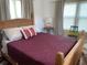 This bedroom features a wooden bed frame with decorative red blanket and a pink lamp at 1020 38Th N Ave, St Petersburg, FL 33704
