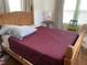 This bedroom features a wooden bed frame with decorative red blanket and a pink lamp at 1020 38Th N Ave, St Petersburg, FL 33704