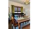Warm dining room features a textured wooden table and matching chairs, complemented by olive green curtains at 1020 38Th N Ave, St Petersburg, FL 33704