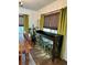 Dining room with wooden table and chairs, green curtains, and bar with stools at 1020 38Th N Ave, St Petersburg, FL 33704