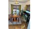 Dining room with a wooden table, green curtains, and a bar with green stools at 1020 38Th N Ave, St Petersburg, FL 33704