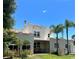 Charming stucco home with a red tile roof, palm trees, and a well-manicured lawn at 1020 38Th N Ave, St Petersburg, FL 33704