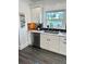 Updated kitchen featuring white cabinets, stainless steel appliances, and stylish dark wood flooring at 1020 38Th N Ave, St Petersburg, FL 33704